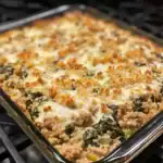 Delicious vegetable and ground meat casserole topped with crispy breadcrumbs, baked to perfection in a glass dish.